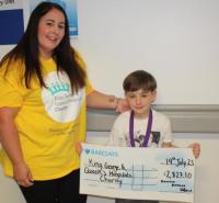 Dominic with his mum Emma and the cheque